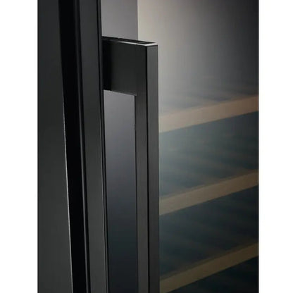 Close-up of a black door handle on a glass door