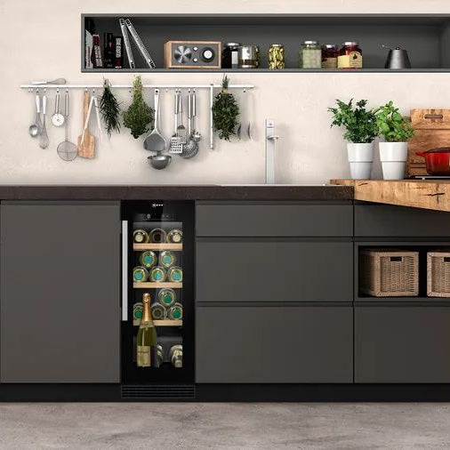 Modern kitchen with dark gray cabinets, a wine cooler, and wooden island.