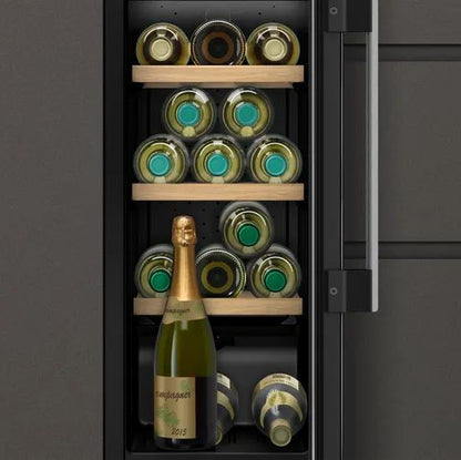 Neff KU9202HF0G fitted between kitchen cabinets, showing wine bottles on wooden shelves behind the glass door.
